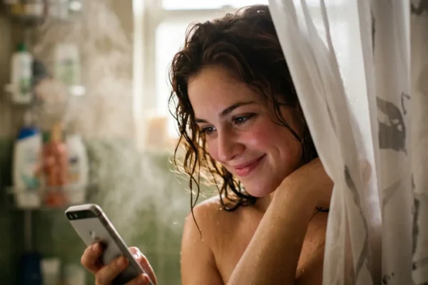 Woman smiling while reading messages in a flirt chat online