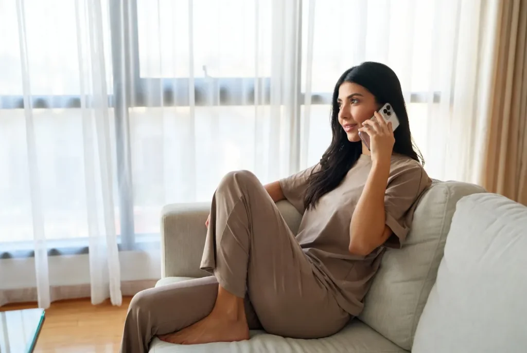 Woman enjoying a voice call through tamil chat at home